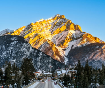 The sun shining on the mountain overlooking Banff The sun shining on the mountain overlooking Banff