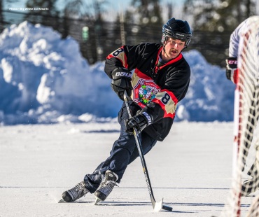 Playing ice hockey in big white jersey Playing ice hockey in big white jersey