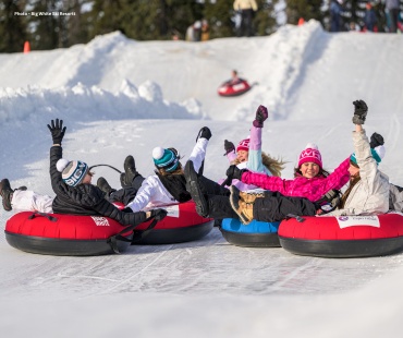 Kids enjoying sliding down the tube park slopes Kids enjoying sliding down the tube park slopes