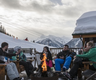 People Relaxing next to the warm fire at Panorama Mountain Resort People Relaxing next to the warm fire at Panorama Mountain Resort