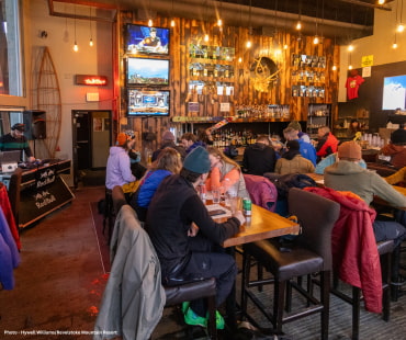 People enjoying craft beers in Mac Tavern at revelstoke People enjoying craft beers in Mac Tavern at revelstoke