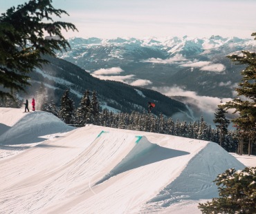 Snowboarder hitting a large jump at Whistler Snowboarder hitting a large jump at Whistler