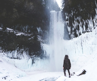 Person looking at the frozen snow around the brandywine Falls Person looking at the frozen snow around the brandywine Falls