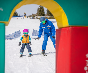 Instructor and young skier learning to ski Instructor and young skier learning to ski