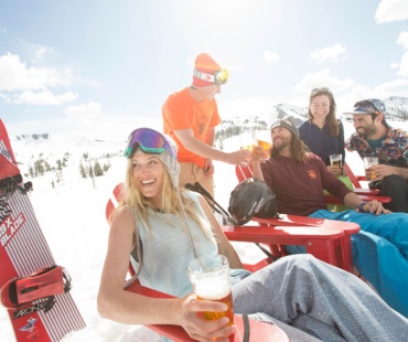 People relaxing on the snow beach enjoying a drink People relaxing on the snow beach enjoying a drink