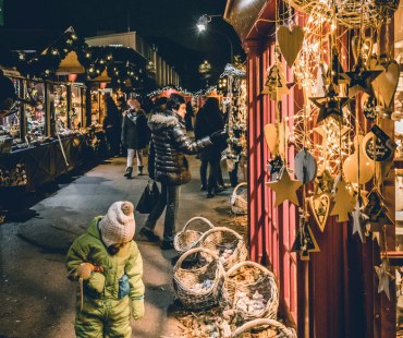 People browsing at the lit up christmas markets People browsing at the lit up christmas markets