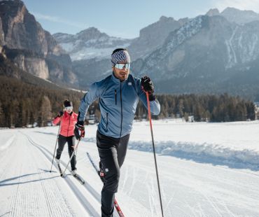 Two people cross country skiing on nordic trails Two people cross country skiing on nordic trails
