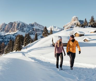 Two people enjoying a walk through the snow Dolomites Two people enjoying a walk through the snow Dolomites