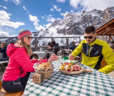 People enjoying wine and cheeseboards with mountain views People enjoying wine and cheeseboards with mountain views