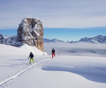 Skiers trekking through peaks of the dolomites Skiers trekking through peaks of the dolomites