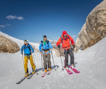 People trekking uphill in the backcountry People trekking uphill in the backcountry