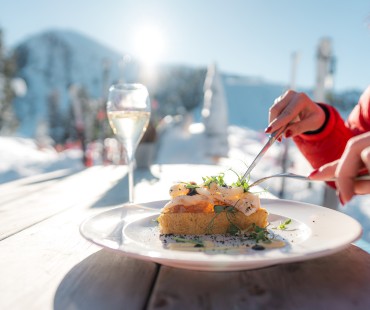 Nicely plated meal and wine with alpine views Nicely plated meal and wine with alpine views