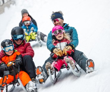Family enjoying the fun sledding trails Family enjoying the fun sledding trails