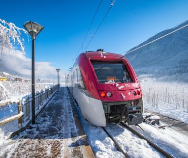 the red train running through the Val di Sole the red train running through the Val di Sole