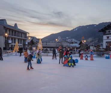Adults and children enjoying skating on the ice rink Adults and children enjoying skating on the ice rink