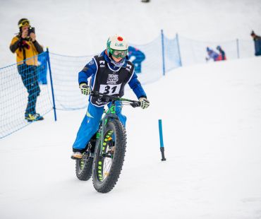 Kid competing in Fat Biking competition Kid competing in Fat Biking competition