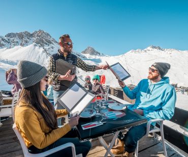 couple being served at mountain restaurant with mountain views couple being served at mountain restaurant with mountain views