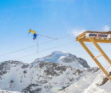 Skier launching off zipline ski jump Skier launching off zipline ski jump