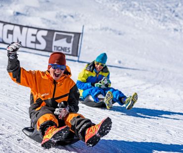 Kids racing sleds down the trails Kids racing sleds down the trails