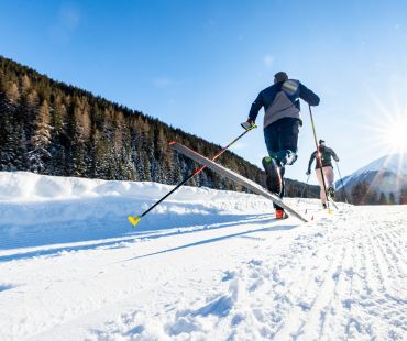People cross country skiing on nordic trails in Davos People cross country skiing on nordic trails in Davos