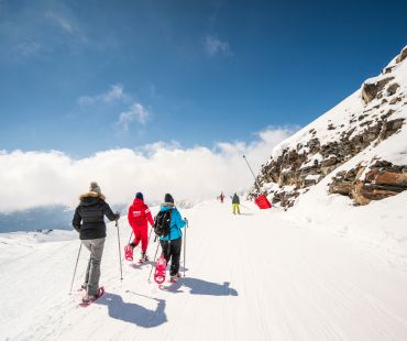 People hiking the snowy trails in snowshoes People hiking the snowy trails in snowshoes