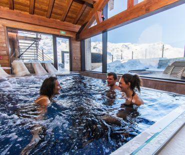 People relaxing in hot spa People relaxing in hot spa