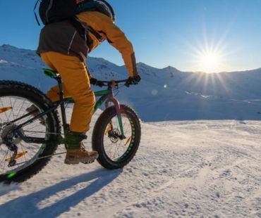 Person riding fat bike on snowy trail Person riding fat bike on snowy trail