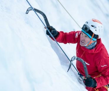 Man climbing up frozen waterfall Man climbing up frozen waterfall