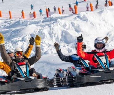 People racing go karts on the snow People racing go karts on the snow