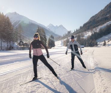 People enjoying the nature while cross country skiing on nordic trails People enjoying the nature while cross country skiing on nordic trails
