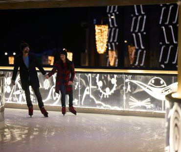 Couple ice skating on the Rink at Ischgl Couple ice skating on the Rink at Ischgl