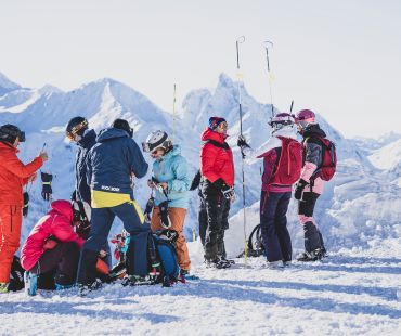 Skiers at the top of the mountain preparing to race in the open Skiers at the top of the mountain preparing to race in the open