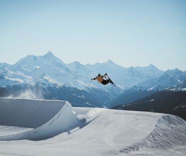 Skier launching off Jump at Crans Montana Skier launching off Jump at Crans Montana