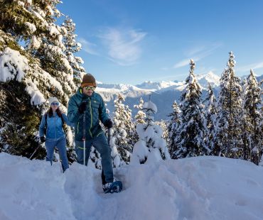 People snowshoeing through fluffy powder snow People snowshoeing through fluffy powder snow