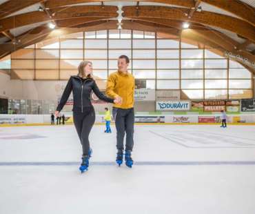 Couple Ice Skating in Val Gardena Couple Ice Skating in Val Gardena
